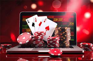 An open laptop with casino chips and cards stacked on top of it, displaying a trusted online casino in South Africa featured